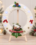 Handcrafted snowy white Christmas wreath with white bird, red berries, bows, pinecone and lights