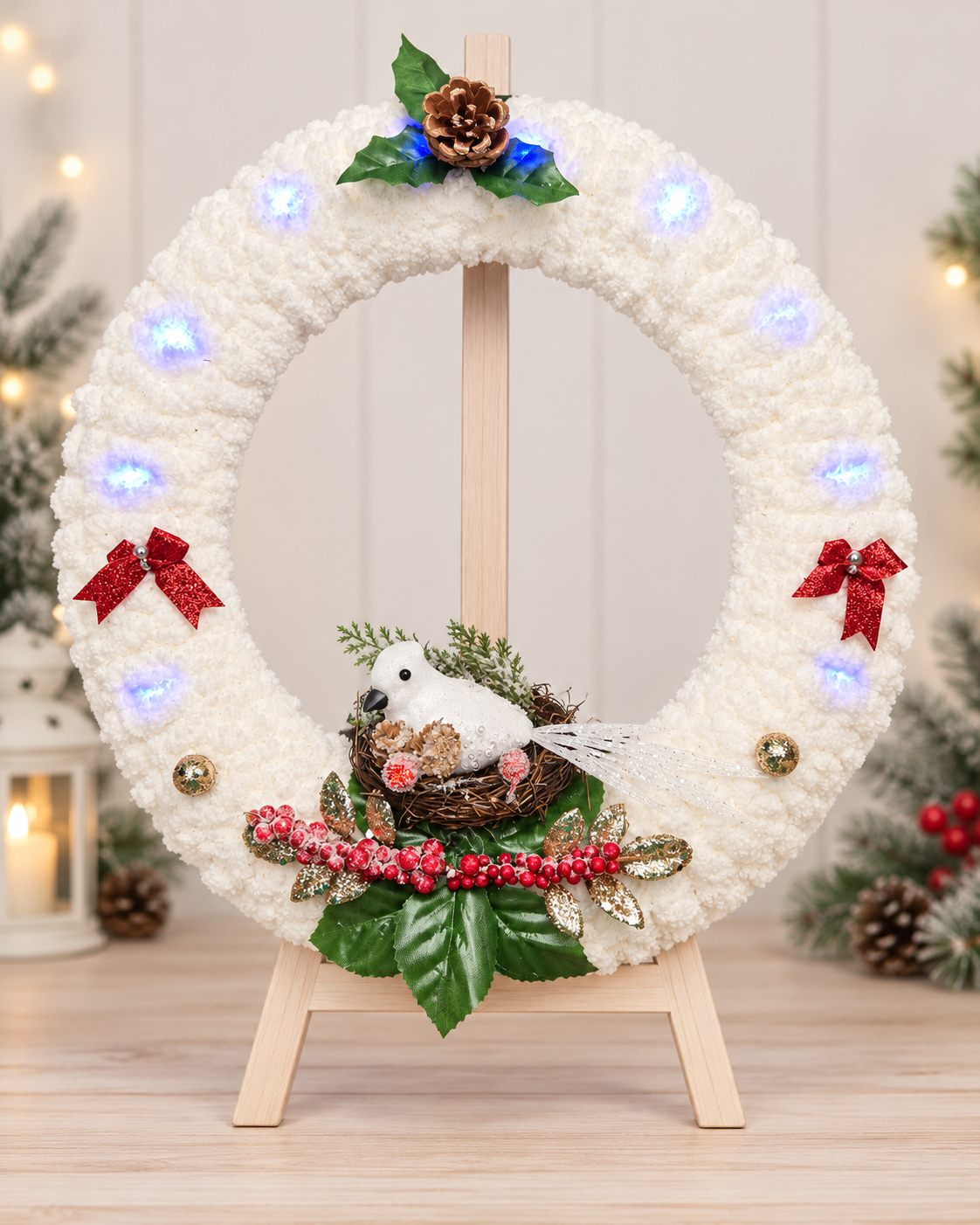 Handcrafted snowy white Christmas wreath with white bird, red berries, bows, pinecone and lights